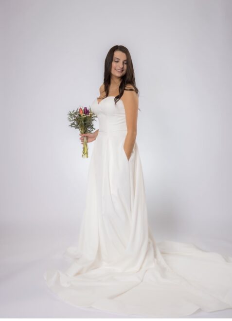 Strapless wedding dress with pockets and long train from bridal boutique in west bend Wisconsin 