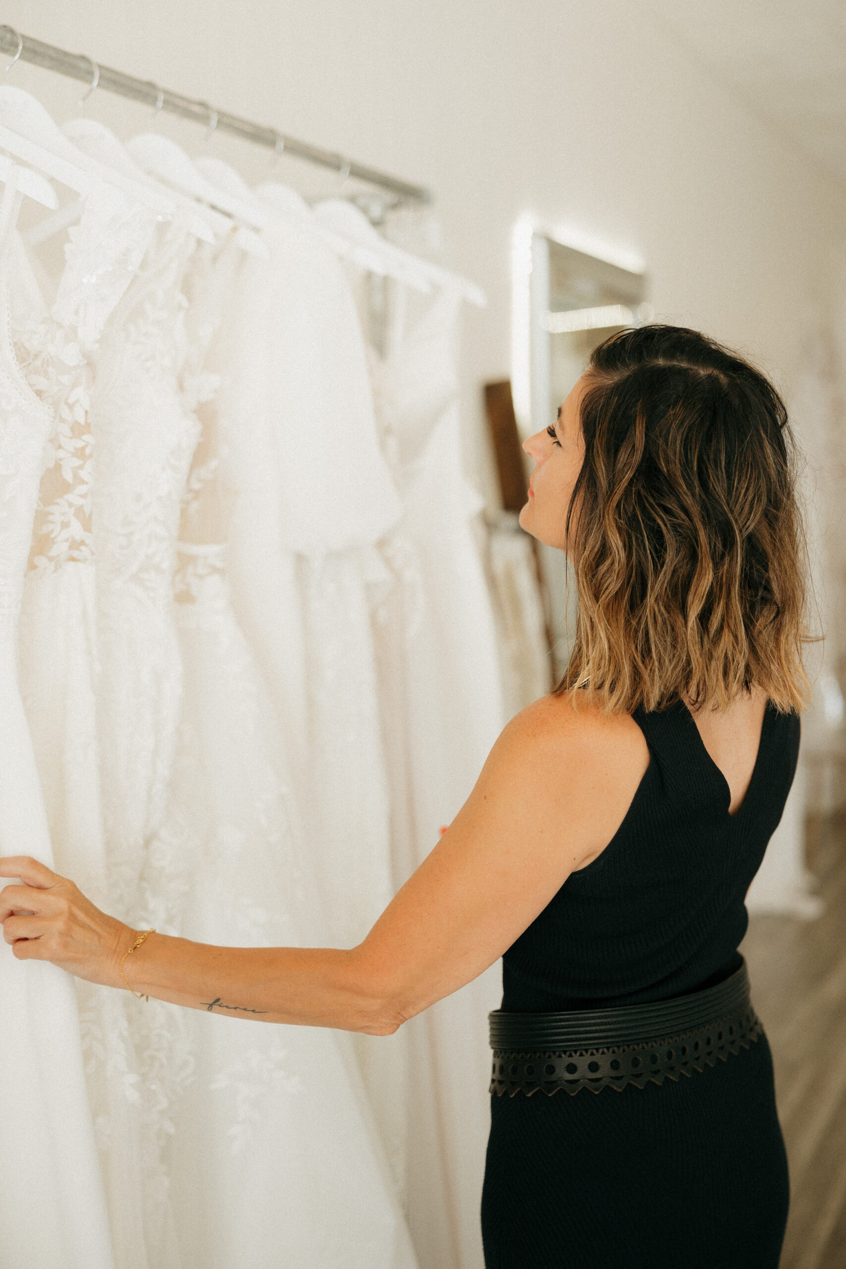 Bridal shop owner with wedding gowns in Wisconsin